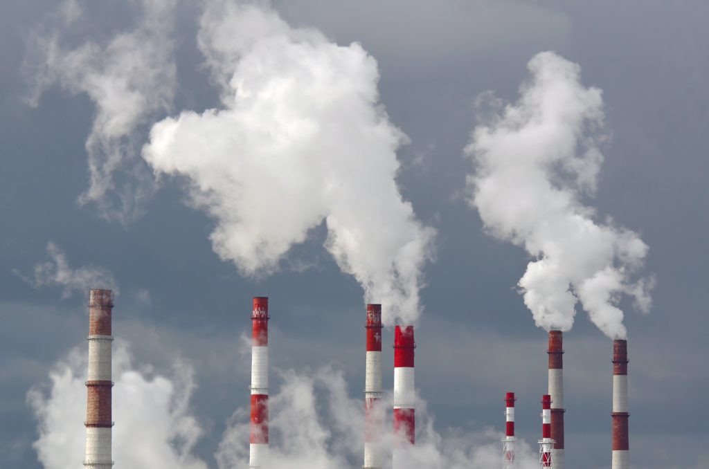 Smoking chimneys against the sky